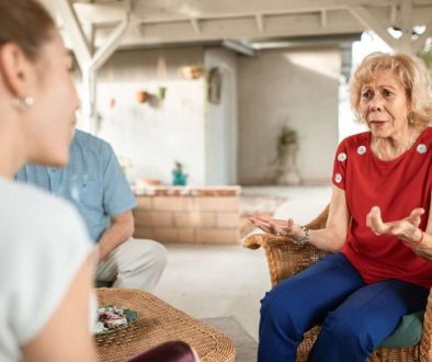 Older mother talking with her adult son and daughter about choosing a trustee